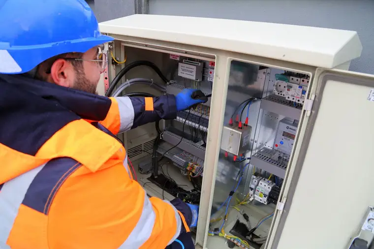 A Brightwire electrician working on a fuse board